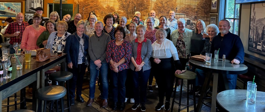 Former Commercial Affairs Division employees gather for a laugh.  May 2025.